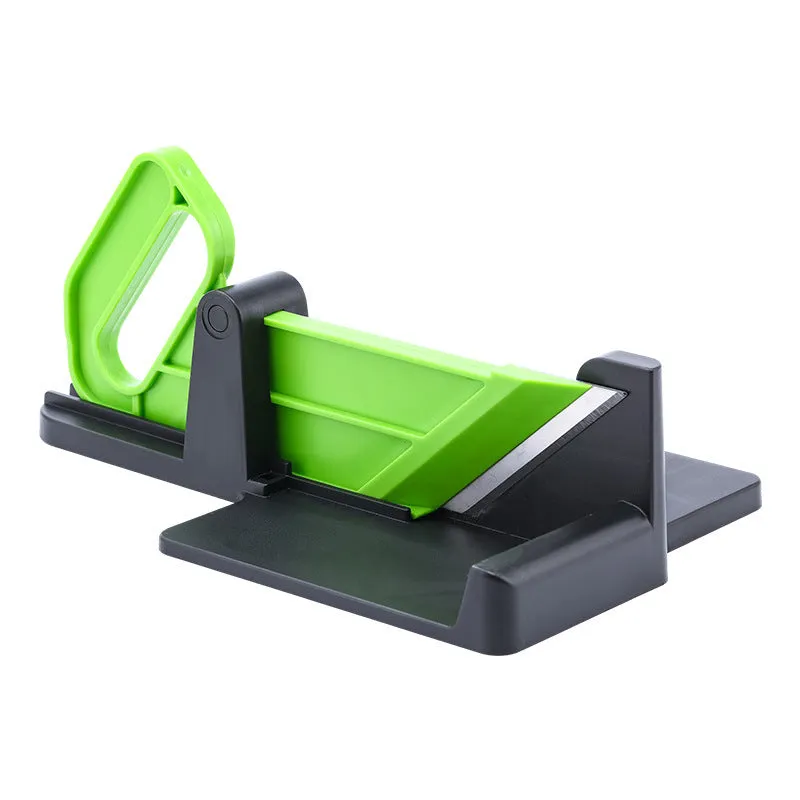Green vegetable cutter with stainless steel blades for carrot and potato slicing in kitchen