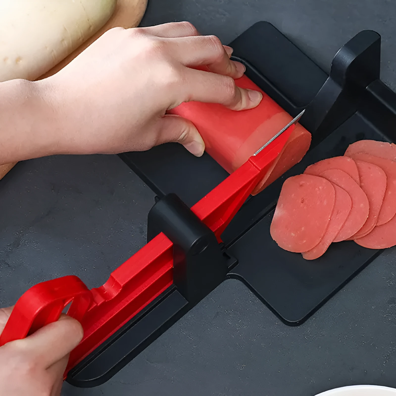 Green vegetable cutter with stainless steel blades for carrot and potato slicing in kitchen