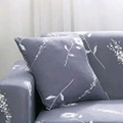 Printed geometric pattern stretch sofa slipcover fitted on a modern three-seater sofa.
