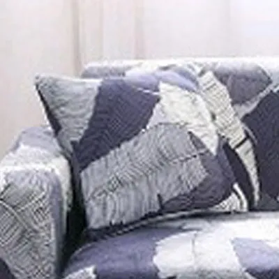 Printed geometric pattern stretch sofa slipcover fitted on a modern three-seater sofa.
