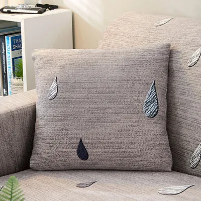 Printed geometric pattern stretch sofa slipcover fitted on a modern three-seater sofa.