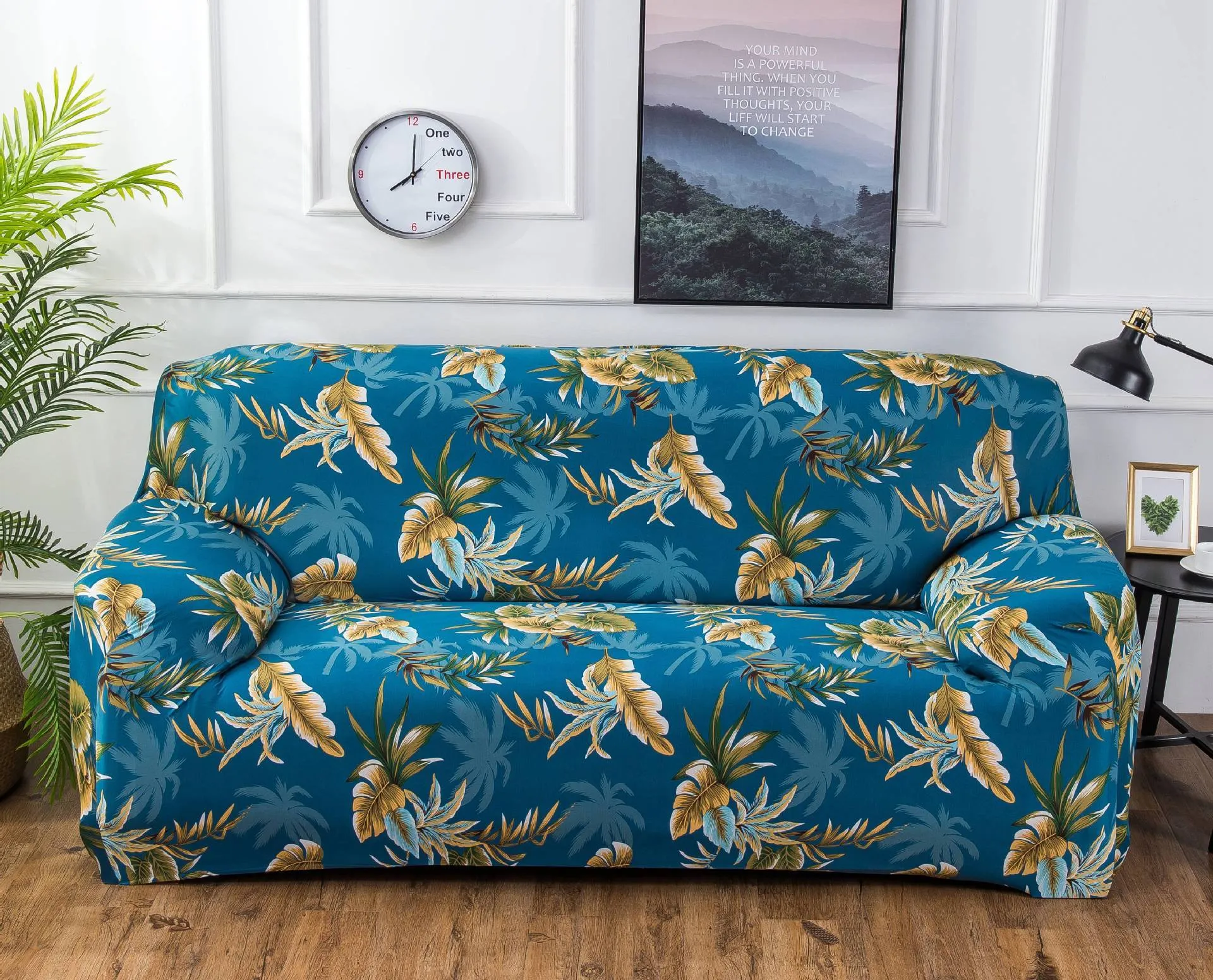 Printed geometric pattern stretch sofa slipcover fitted on a modern three-seater sofa.