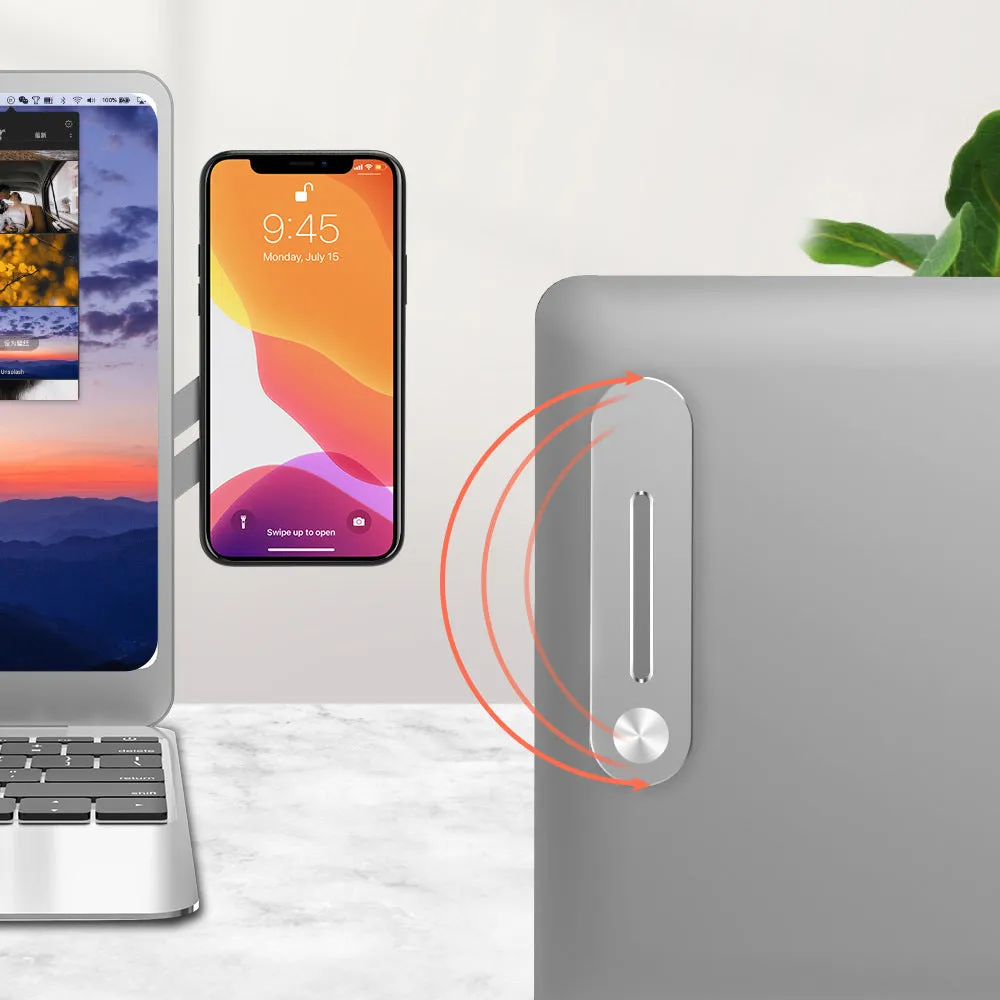Silver aluminium laptop extension bracket holding a phone next to a computer screen.