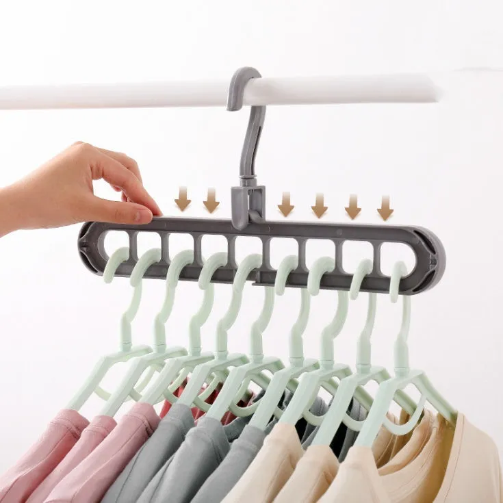 Plastic clothes hanger with a white hook on a pink background, showing its 33 cm length and rotatable handle.
