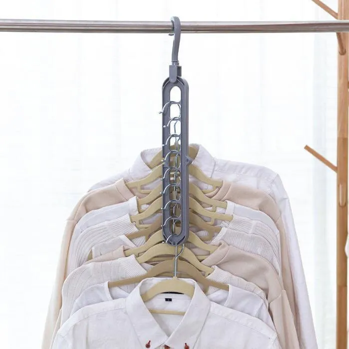 Plastic clothes hanger with a white hook on a pink background, showing its 33 cm length and rotatable handle.