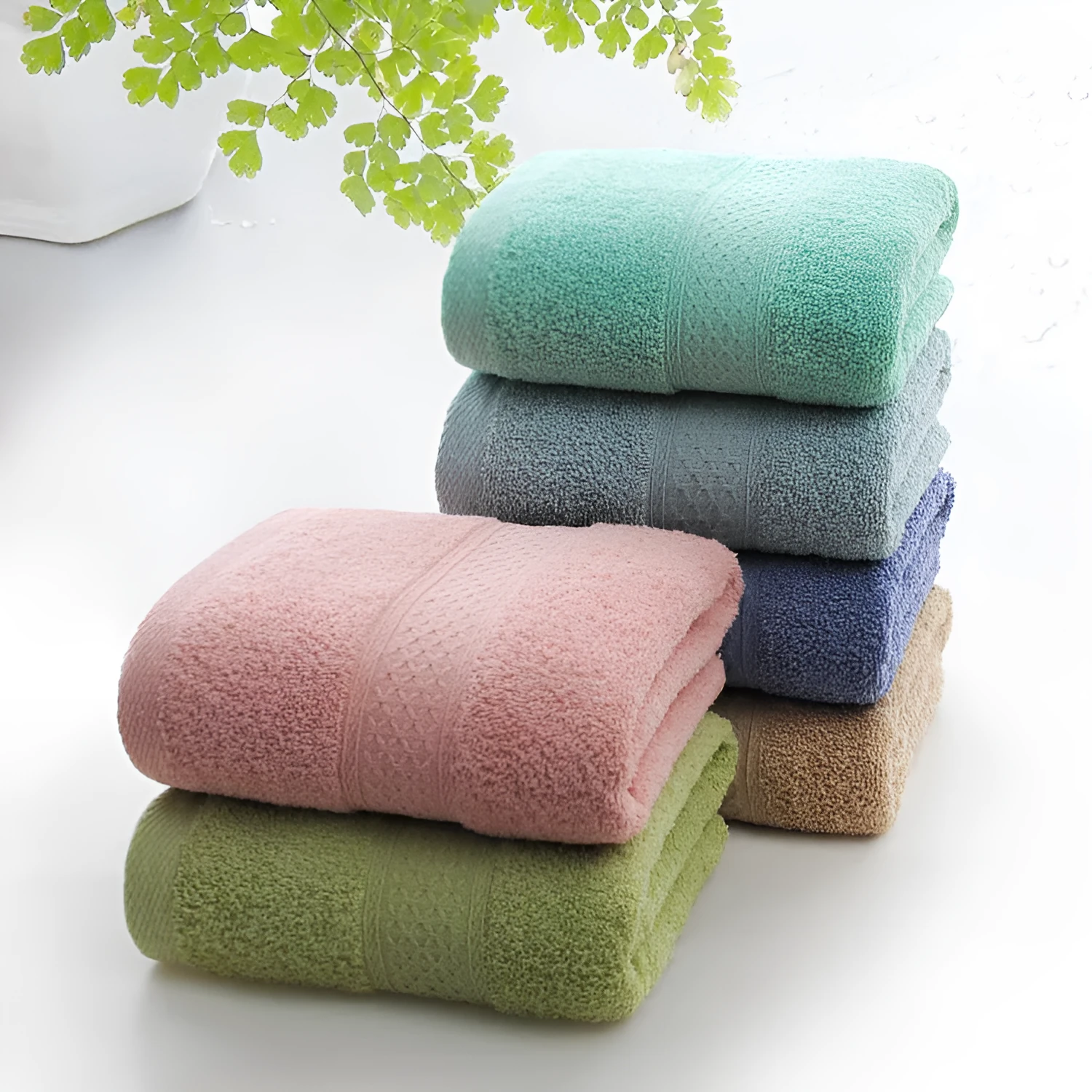 Thick bath and beach towels in seven colour options including apple green, dark blue, and light pink