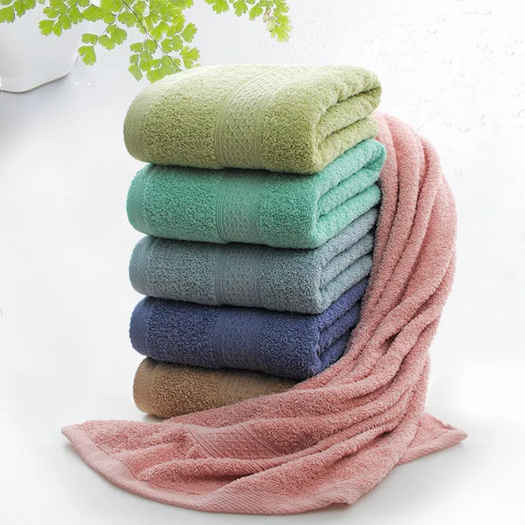 Thick bath and beach towels in seven colour options including apple green, dark blue, and light pink