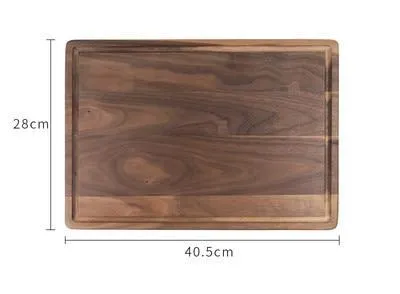 Solid black walnut wood chopping board with a deep perimeter groove and a side handle, shown as a serving tray.