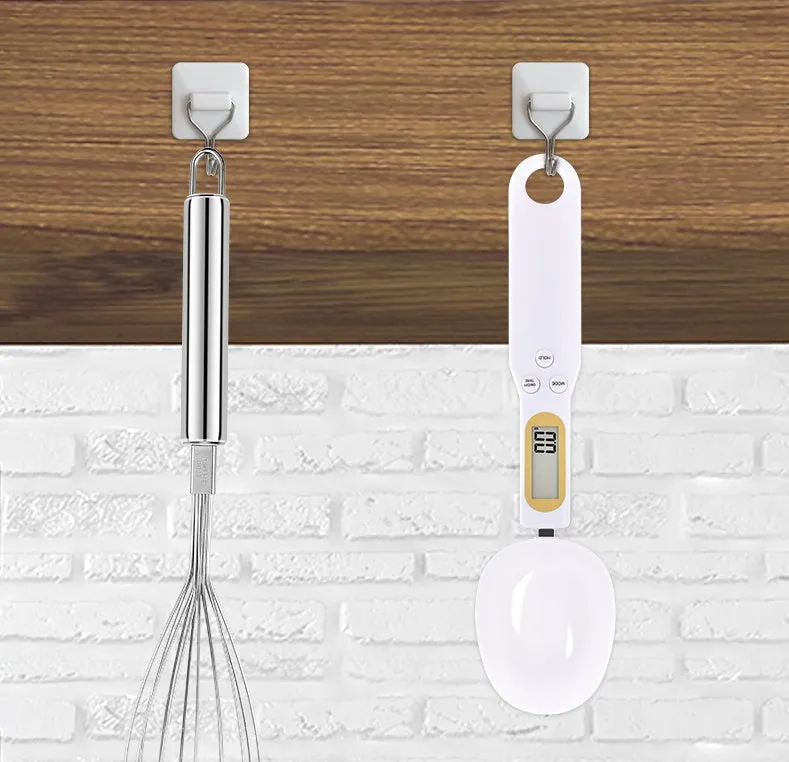 Black digital measuring spoon scale showing 0.0g display on LCD screen with 500g capacity
