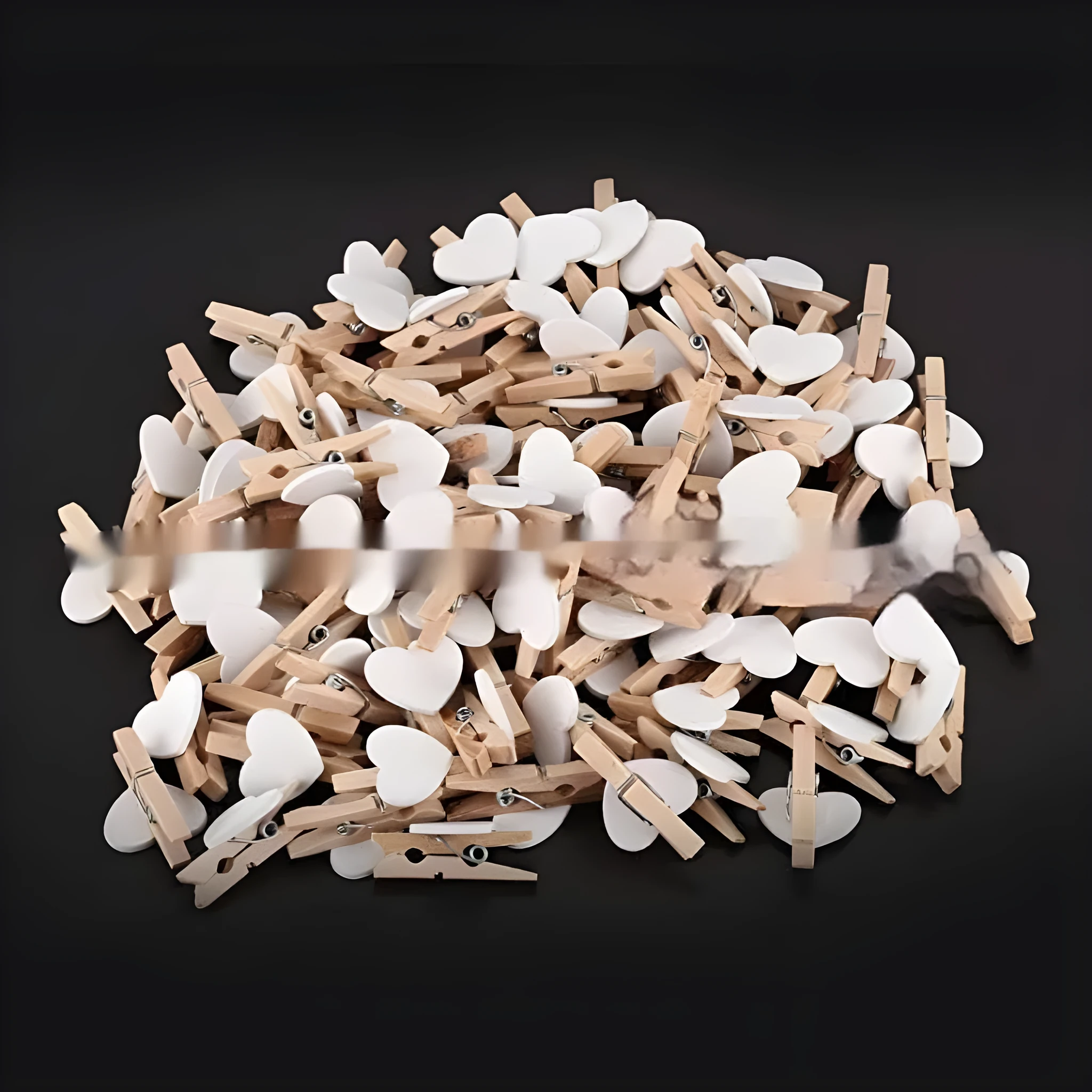 Five small wooden heart-shaped clips in red, pink, yellow, white, and rose red colours on a neutral background.