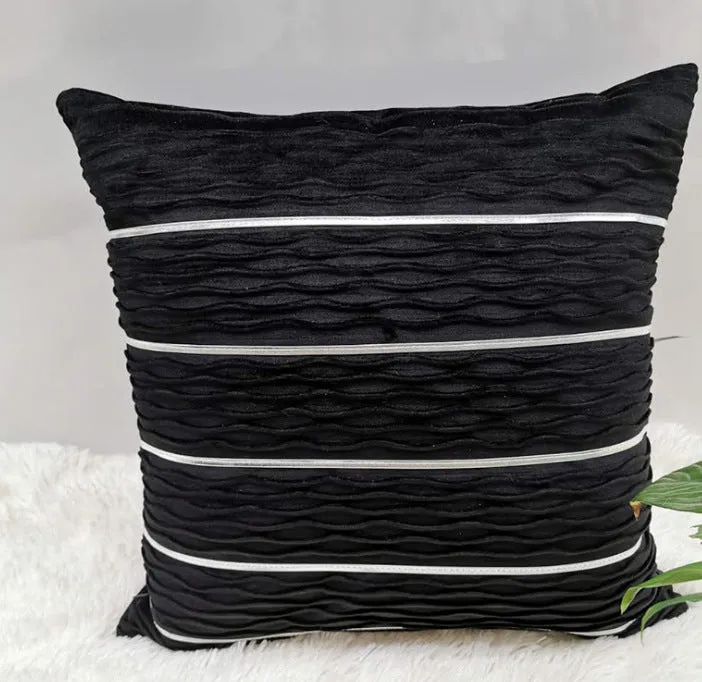 Soft striped velvet pillow cover for a sofa cushion in silver grey colour, shown on a chair.