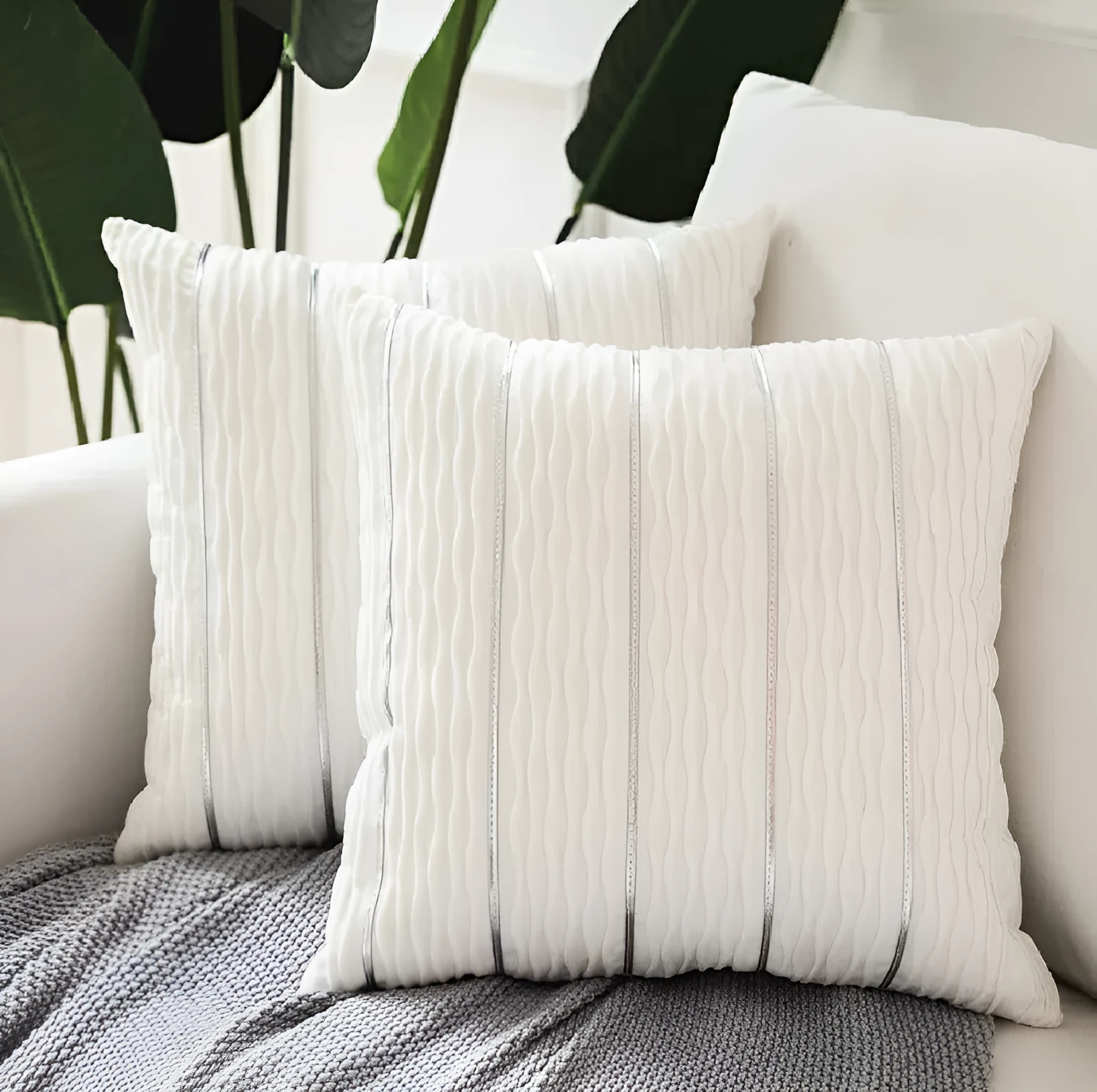Soft striped velvet pillow cover for a sofa cushion in silver grey colour, shown on a chair.