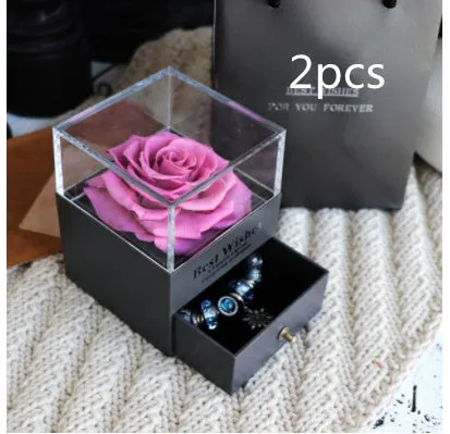 Blue eternal flower gift box with roses and carnations, dimensions 8.5 by 8.5 by 10.5 cm.