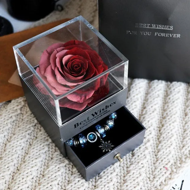 Blue eternal flower gift box with roses and carnations, dimensions 8.5 by 8.5 by 10.5 cm.