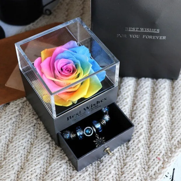 Blue eternal flower gift box with roses and carnations, dimensions 8.5 by 8.5 by 10.5 cm.