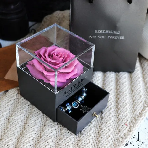Blue eternal flower gift box with roses and carnations, dimensions 8.5 by 8.5 by 10.5 cm.
