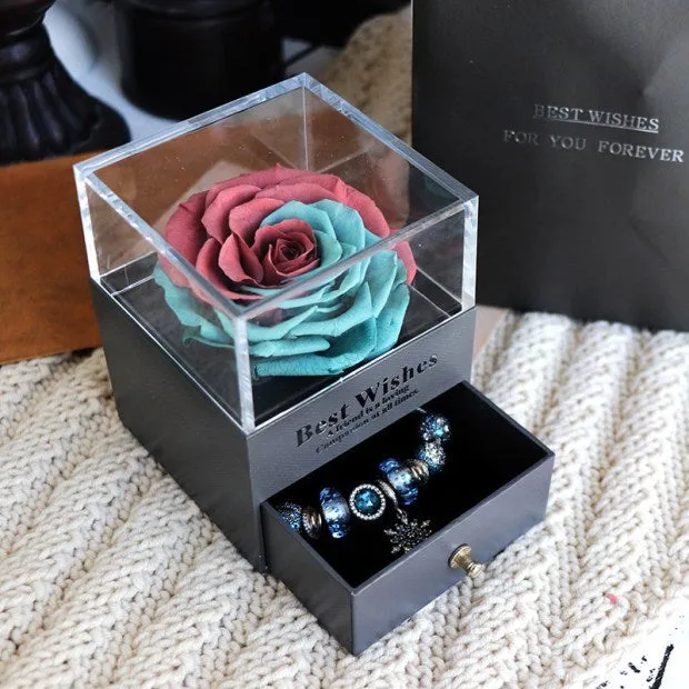 Blue eternal flower gift box with roses and carnations, dimensions 8.5 by 8.5 by 10.5 cm.