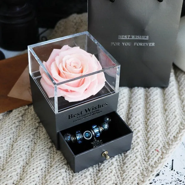 Blue eternal flower gift box with roses and carnations, dimensions 8.5 by 8.5 by 10.5 cm.