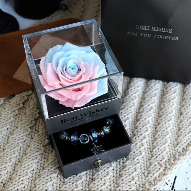 Blue eternal flower gift box with roses and carnations, dimensions 8.5 by 8.5 by 10.5 cm.