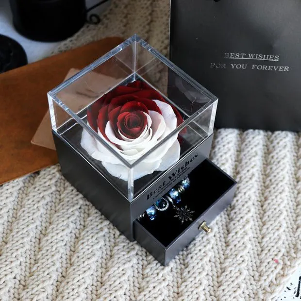 Blue eternal flower gift box with roses and carnations, dimensions 8.5 by 8.5 by 10.5 cm.