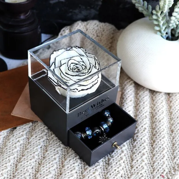 Blue eternal flower gift box with roses and carnations, dimensions 8.5 by 8.5 by 10.5 cm.