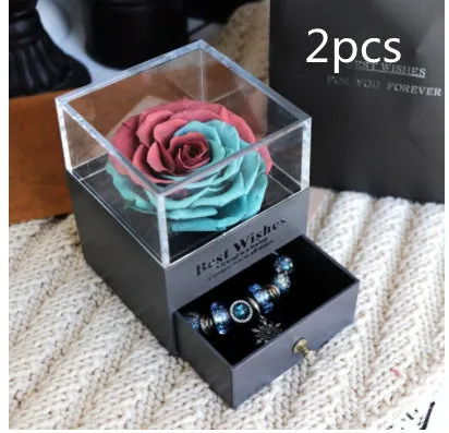Blue eternal flower gift box with roses and carnations, dimensions 8.5 by 8.5 by 10.5 cm.