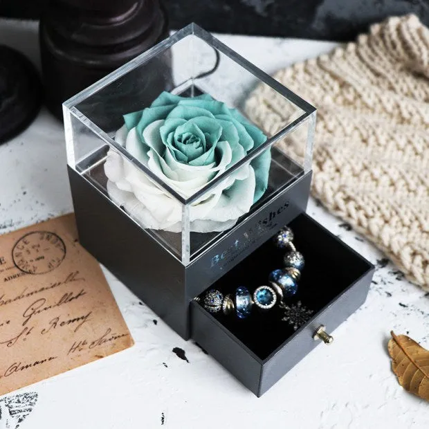 Blue eternal flower gift box with roses and carnations, dimensions 8.5 by 8.5 by 10.5 cm.