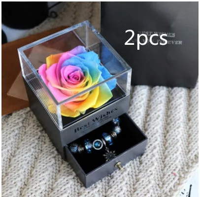 Blue eternal flower gift box with roses and carnations, dimensions 8.5 by 8.5 by 10.5 cm.
