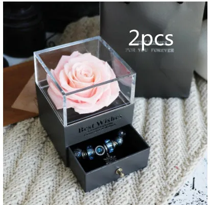 Blue eternal flower gift box with roses and carnations, dimensions 8.5 by 8.5 by 10.5 cm.