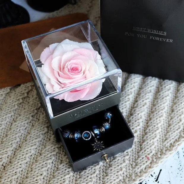 Blue eternal flower gift box with roses and carnations, dimensions 8.5 by 8.5 by 10.5 cm.