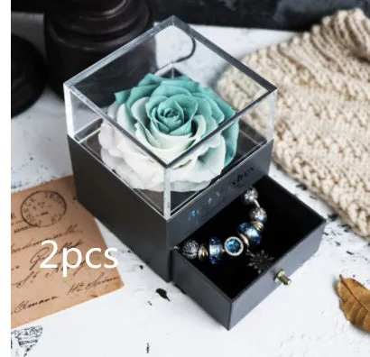 Blue eternal flower gift box with roses and carnations, dimensions 8.5 by 8.5 by 10.5 cm.