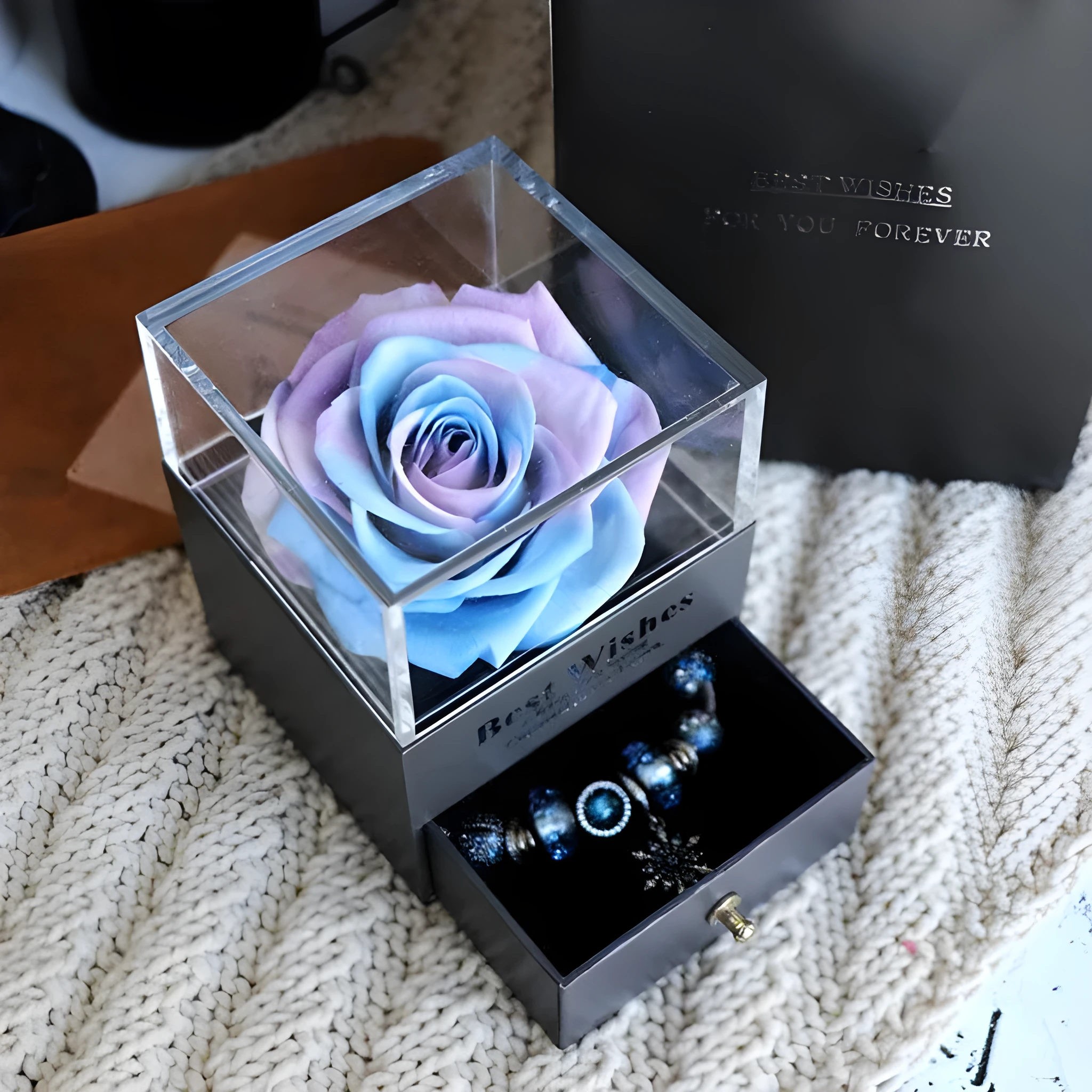 Blue eternal flower gift box with roses and carnations, dimensions 8.5 by 8.5 by 10.5 cm.