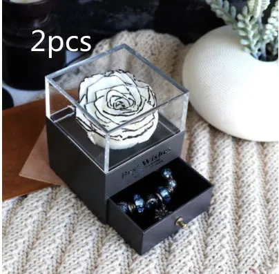 Blue eternal flower gift box with roses and carnations, dimensions 8.5 by 8.5 by 10.5 cm.