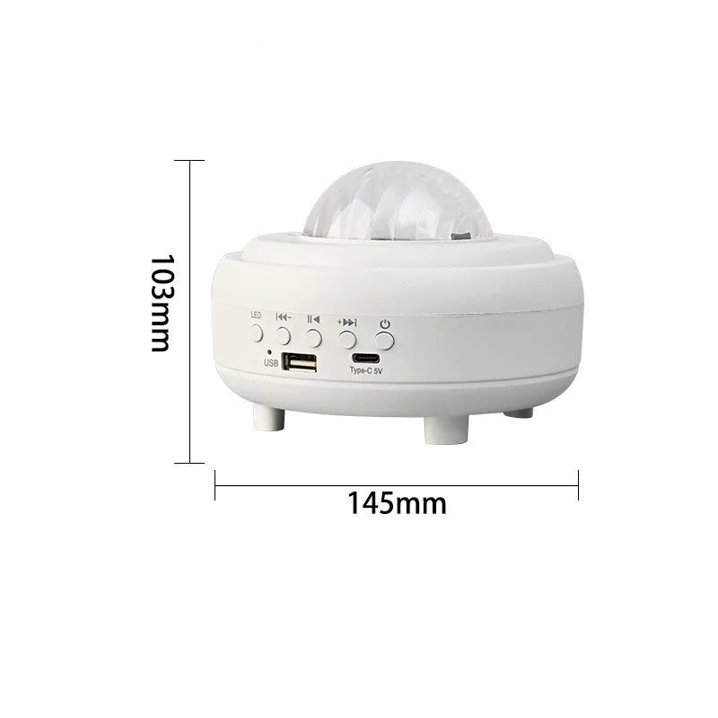 White Galaxy Star Projector Night Light on a table projecting blue starry sky onto a ceiling.