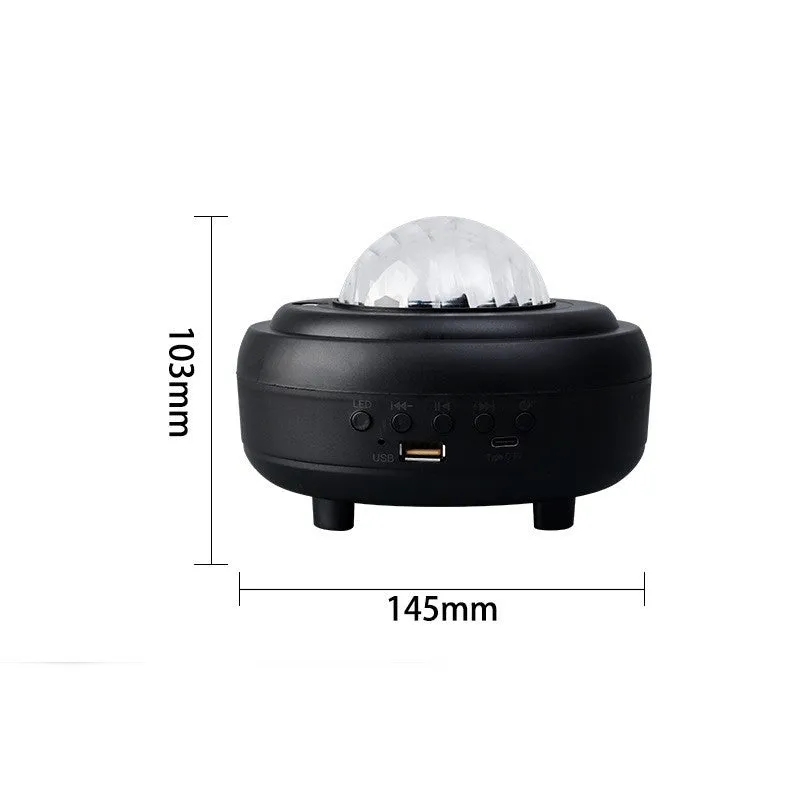 White Galaxy Star Projector Night Light on a table projecting blue starry sky onto a ceiling.