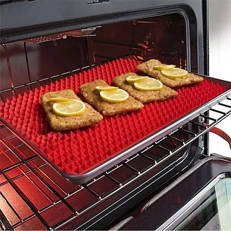 Red silicone pyramid grid cooking mat on a kitchen countertop.