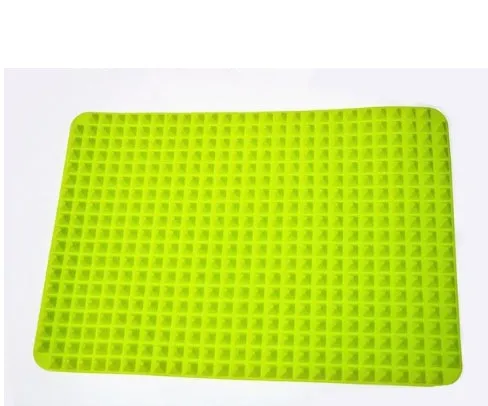 Red silicone pyramid grid cooking mat on a kitchen countertop.