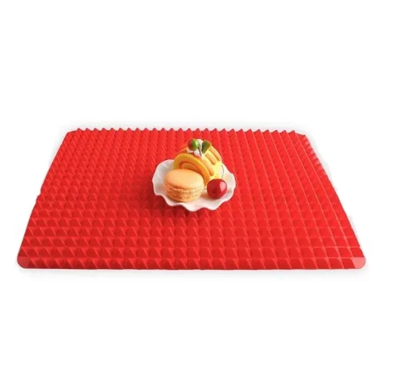 Red silicone pyramid grid cooking mat on a kitchen countertop.