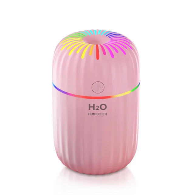 Mini animal-shaped USB humidifier and aromatherapy diffuser in green on a car dashboard.
