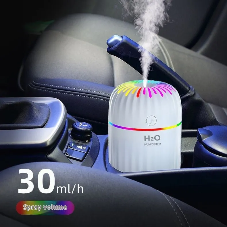 Mini animal-shaped USB humidifier and aromatherapy diffuser in green on a car dashboard.