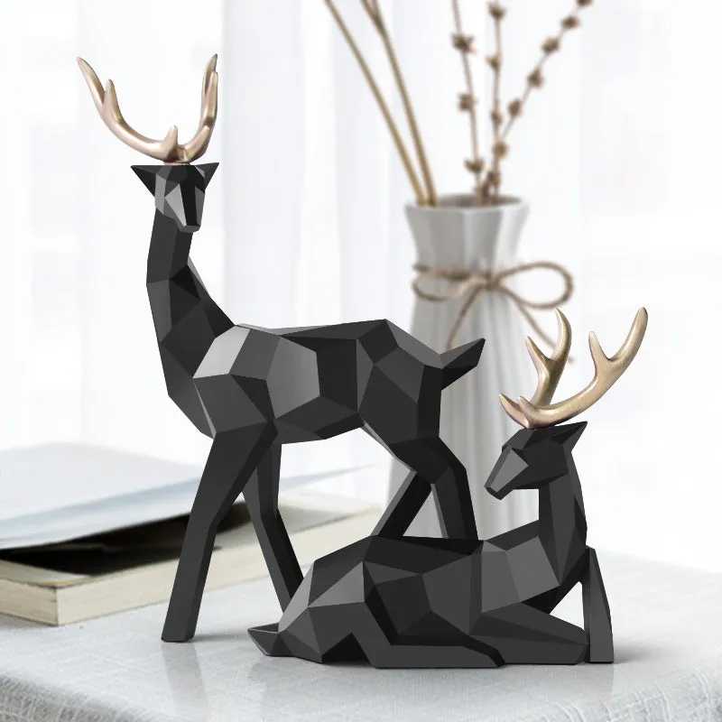 Set of three modern resin deer statues in graduated sizes on a shelf