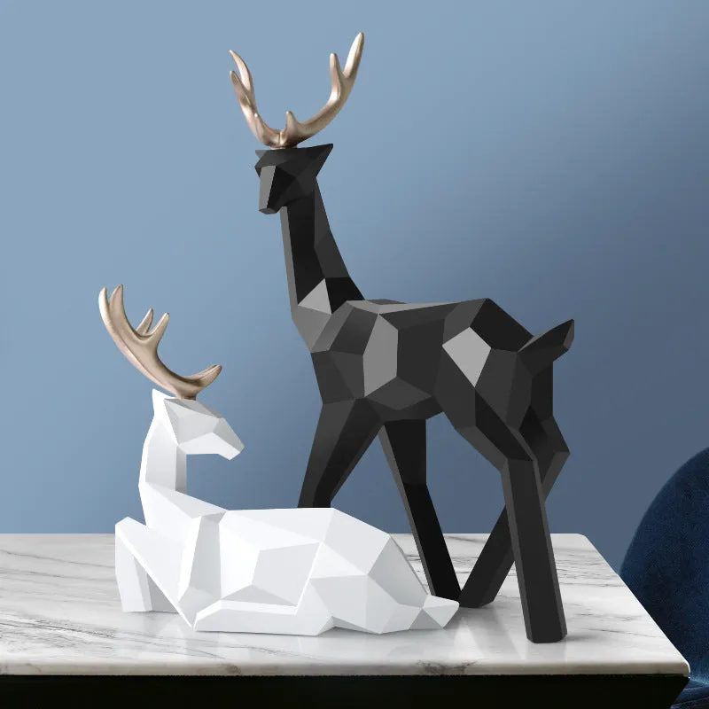 Set of three modern resin deer statues in graduated sizes on a shelf