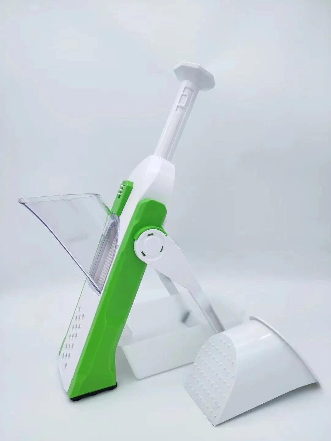 White and blue multifunctional vegetable slicer with stainless steel blades on a kitchen counter