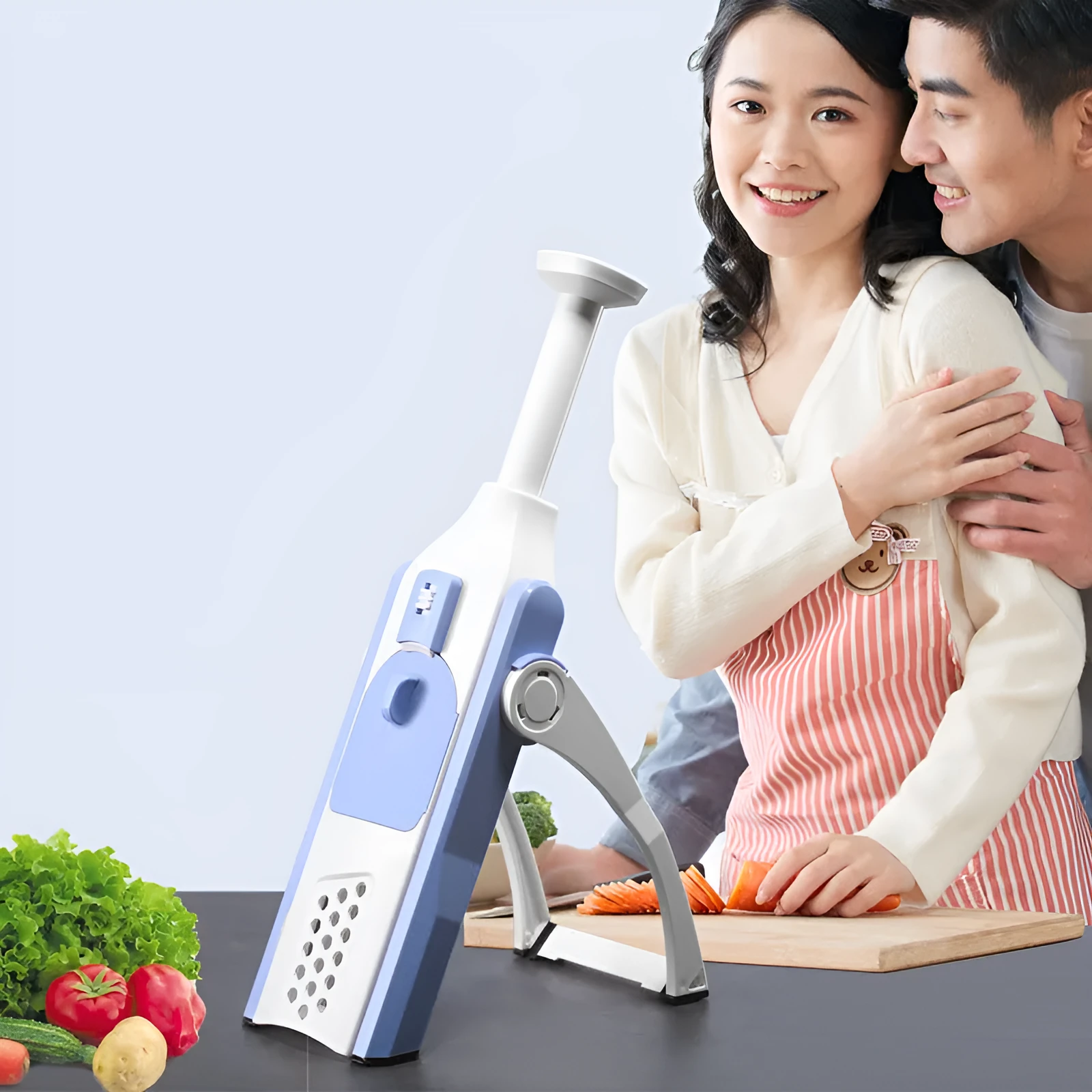 White and blue multifunctional vegetable slicer with stainless steel blades on a kitchen counter