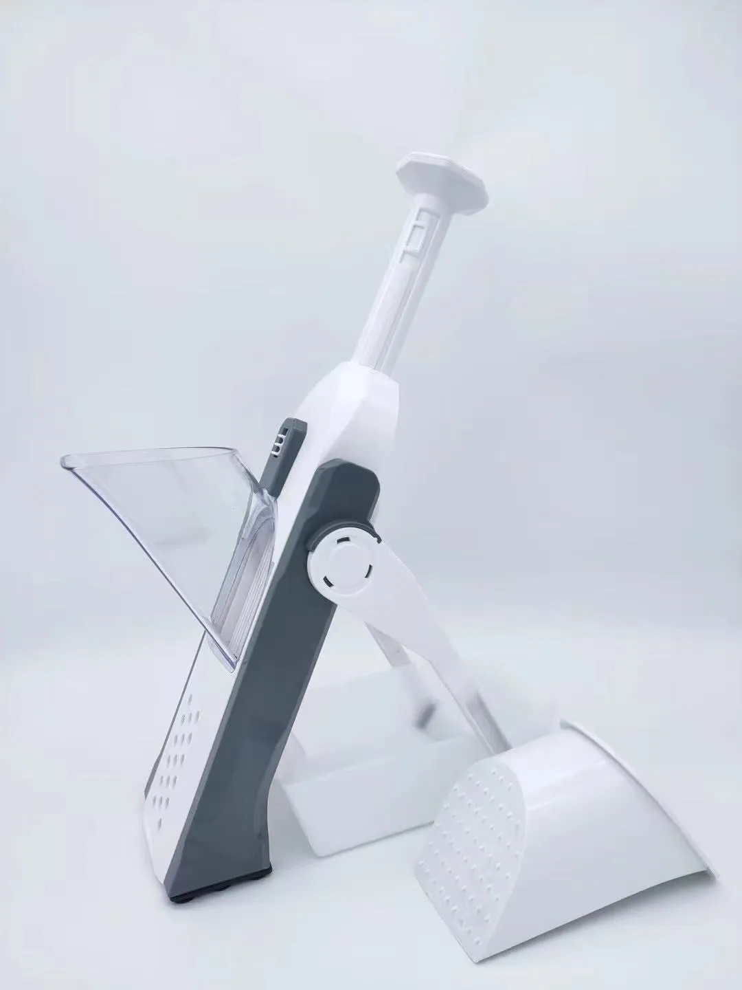 White and blue multifunctional vegetable slicer with stainless steel blades on a kitchen counter