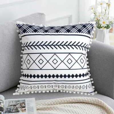 Bohemian national style throw pillow cushion cover in light grey on a sofa.