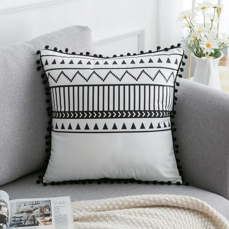 Bohemian national style throw pillow cushion cover in light grey on a sofa.