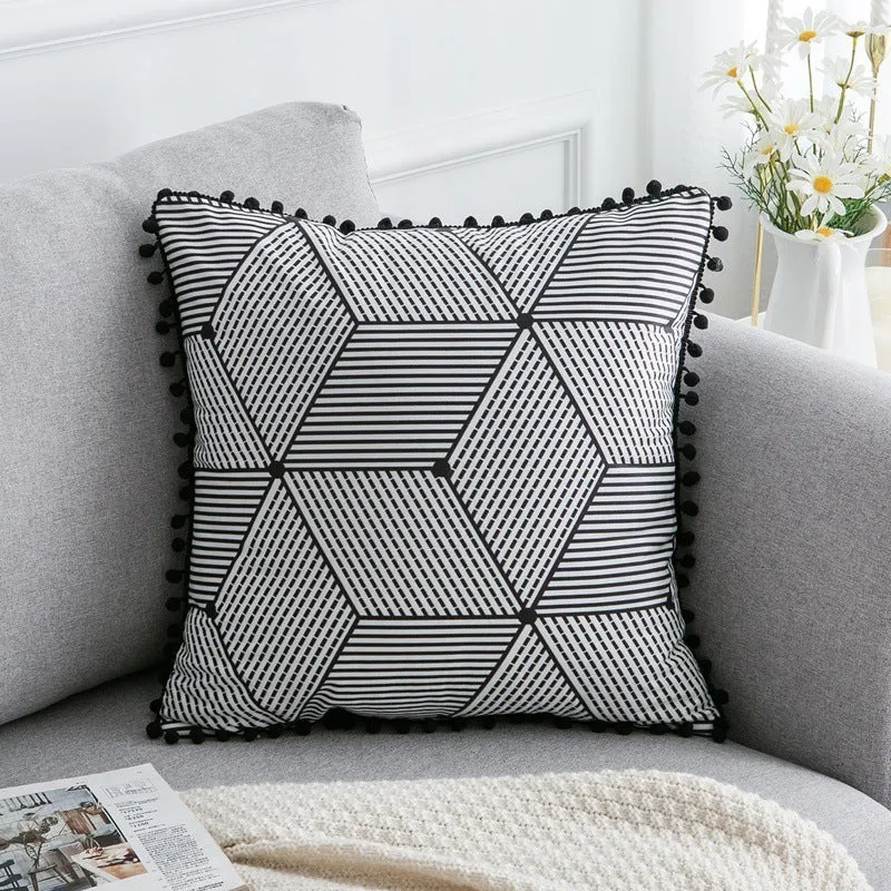 Bohemian national style throw pillow cushion cover in light grey on a sofa.