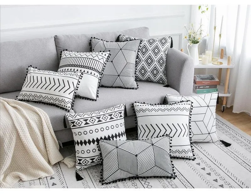 Bohemian national style throw pillow cushion cover in light grey on a sofa.