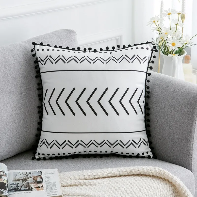 Bohemian national style throw pillow cushion cover in light grey on a sofa.